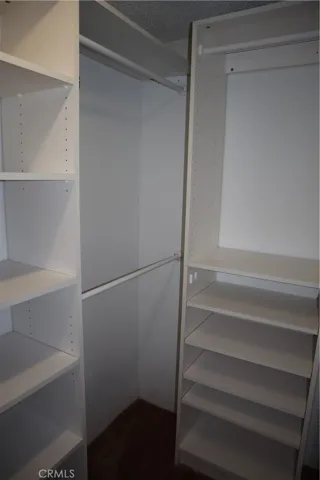 Large walk-in closet with built in storage and racks