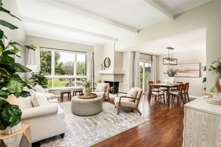 Light-filled living room w/beamed ceilings & romantic fireplace!