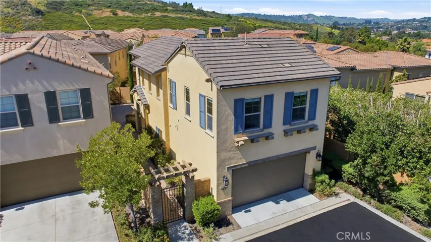 Charming exterior with timeless architectural details, featuring a private entry, well-maintained landscaping, and a desirable end-unit location offering added privacy.