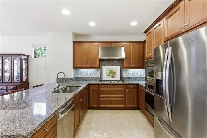 Well-appointed kitchen featuring granite countertops, stainless steel appliances, and ample cabinetry designed for both functionality and everyday living.