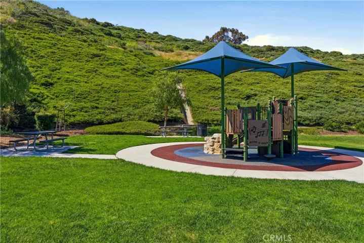 Beautifully maintained community park featuring a shaded playground, open green space, and scenic hillside surroundings—perfect for outdoor enjoyment.