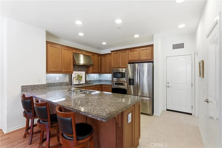 Spacious kitchen with oversized island and bar seating, perfect for casual dining, entertaining, and gathering.