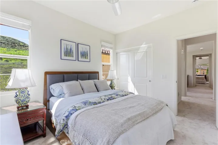 Spacious and inviting bedroom filled with natural light, offering a comfortable layout and peaceful views of the surrounding hills.