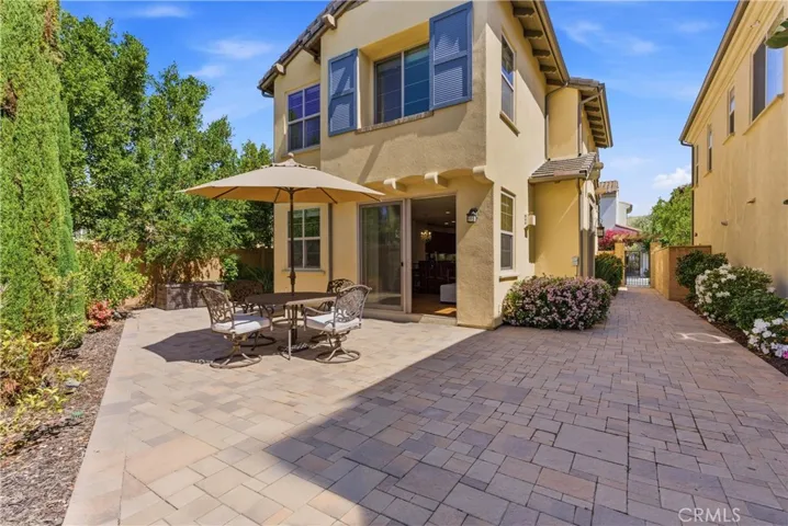 Spacious backyard designed for indoor-outdoor living, featuring a large paver patio and direct access to the home’s main living areas.