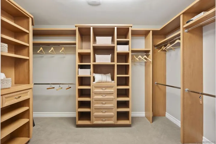 A thoughtfully designed walk-in closet, where custom shelving, generous storage, and an organized layout create a refined space for effortless daily living.