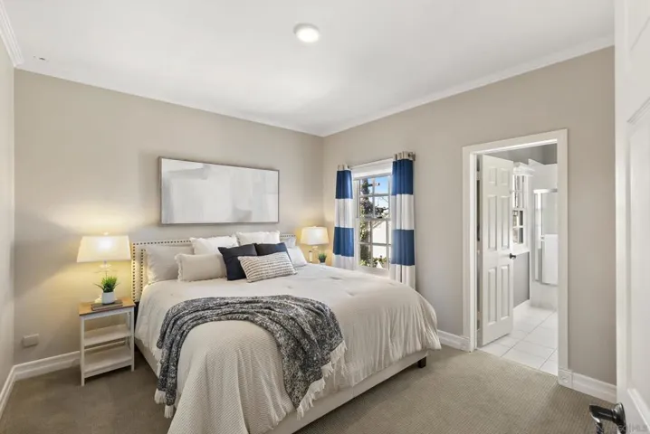 A bright and inviting second bedroom, where soft natural light and a calm, neutral palette create a comfortable retreat for guests or everyday living.
