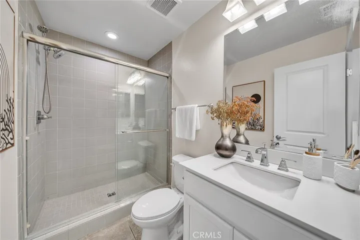 The lower-level bathroom is equipped with a walk-in shower.