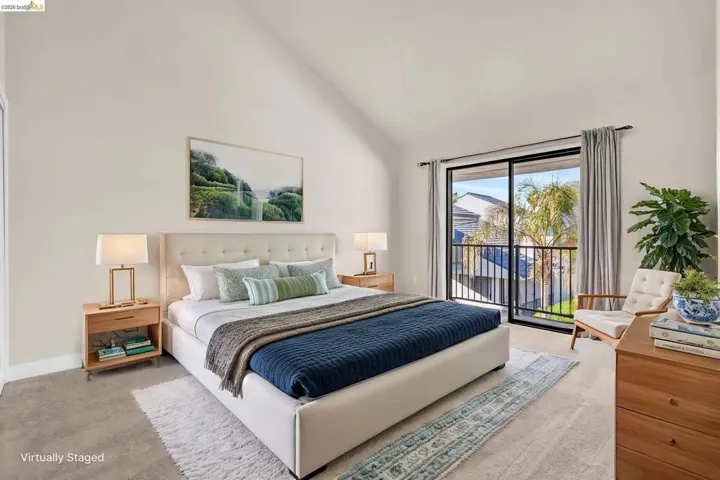 Bedroom featuring access to outside and lofted ceiling