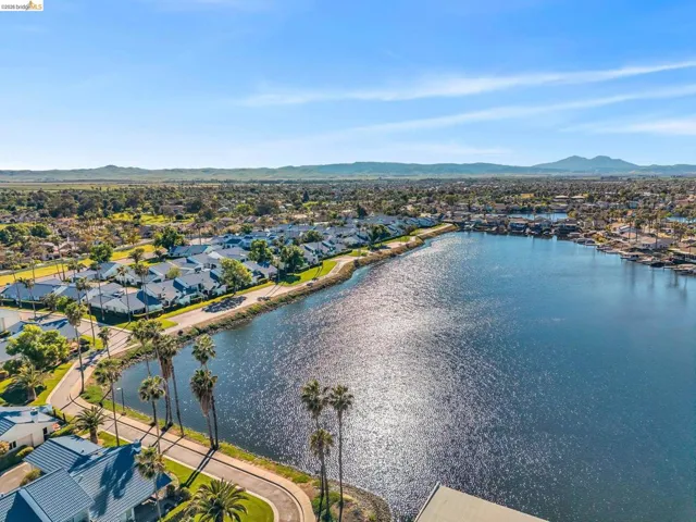 Aerial perspective of suburban area with a water and mountain view