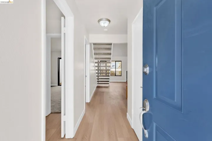 Entryway with light wood-type flooring and baseboards