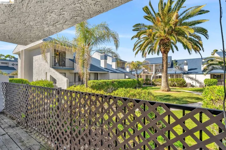 View of front of home with a balcony and stucco siding