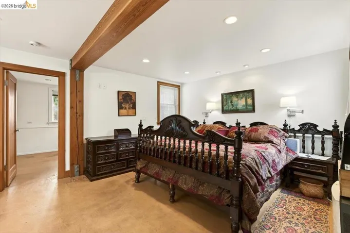 Bedroom featuring multiple windows, recessed lighting, and beam ceiling