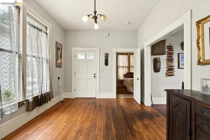 Entryway featuring dark wood finished floors and a chandelier