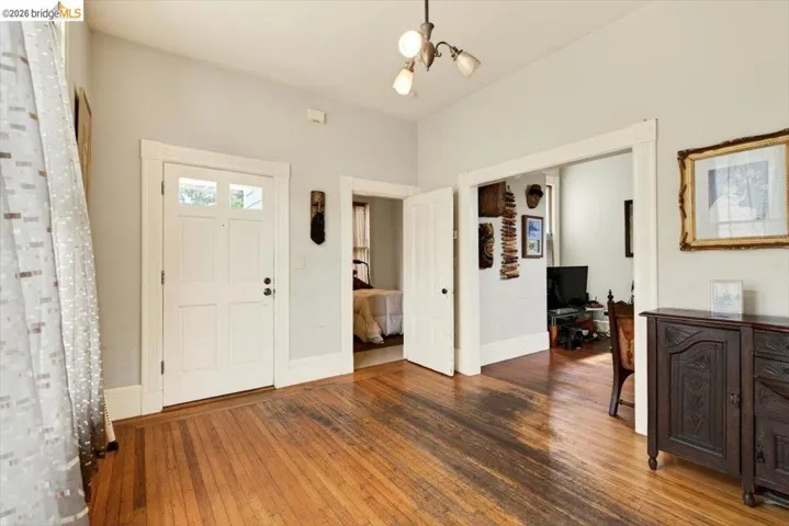 Entrance foyer featuring hardwood / wood-style floors and suspended lighting