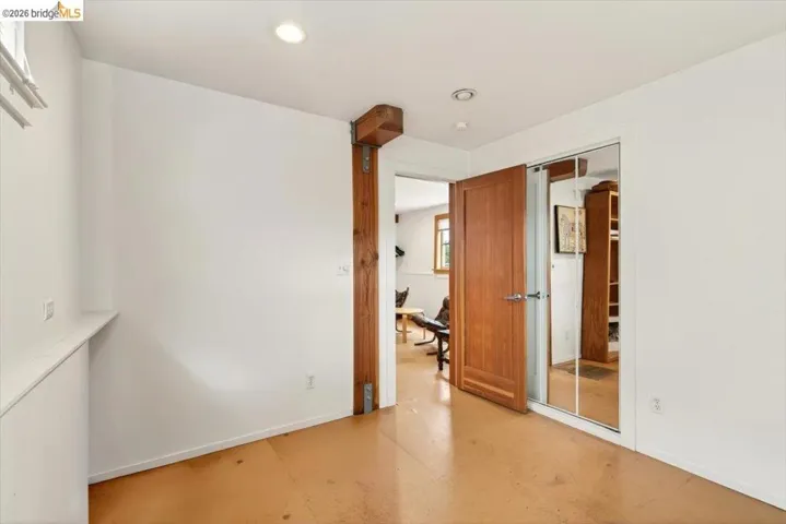 Unfurnished bedroom featuring a closet, concrete flooring, and recessed lighting