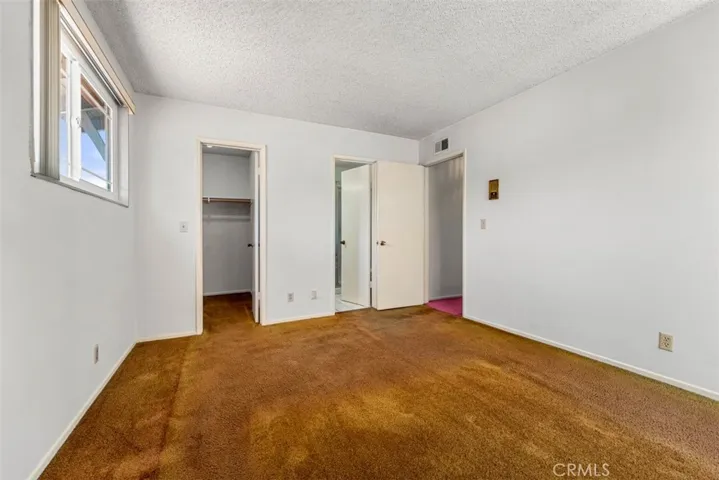 primary bedroom with walking closet and primary bath