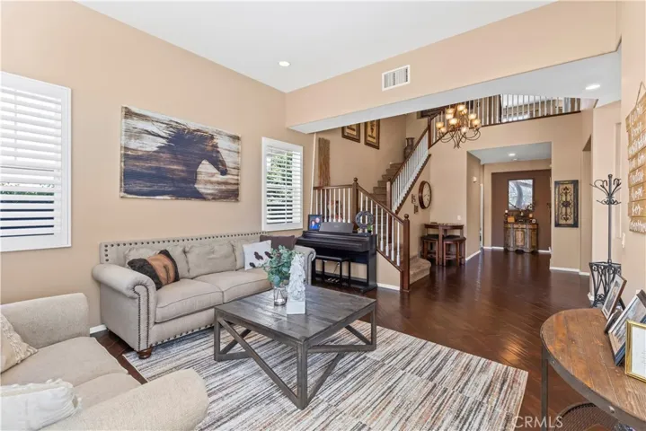 Formal living room looking towards one of two staircases.