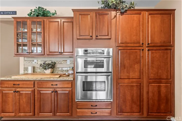 Maple cabinets with a Mullion glass cabinet plus a built-in microwave and second oven.