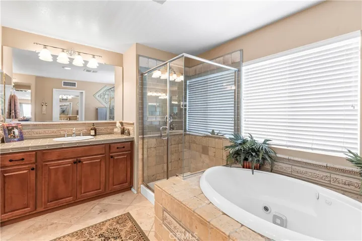 Jetted bathtub with custom stone work all around.