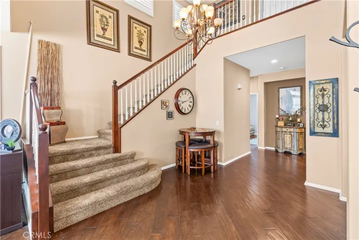 Walking in from the front door you will see the first of two staircases and rich hardwood floor.