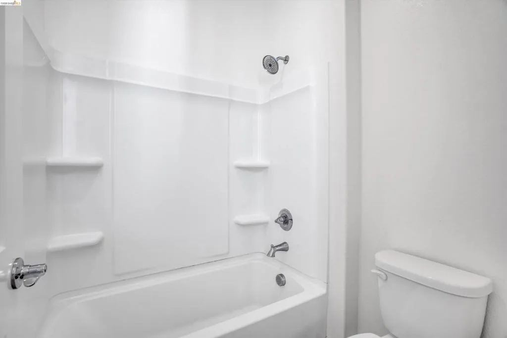 Bathroom with toilet and shower / bath combination