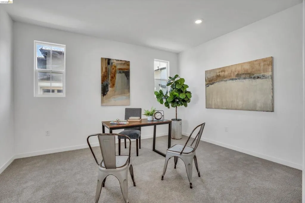 Carpeted home office with baseboards