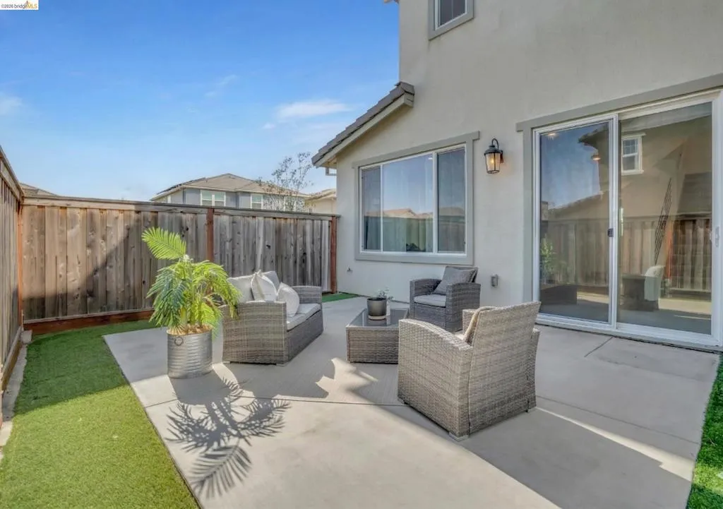 Fenced backyard with outdoor seating and a patio area