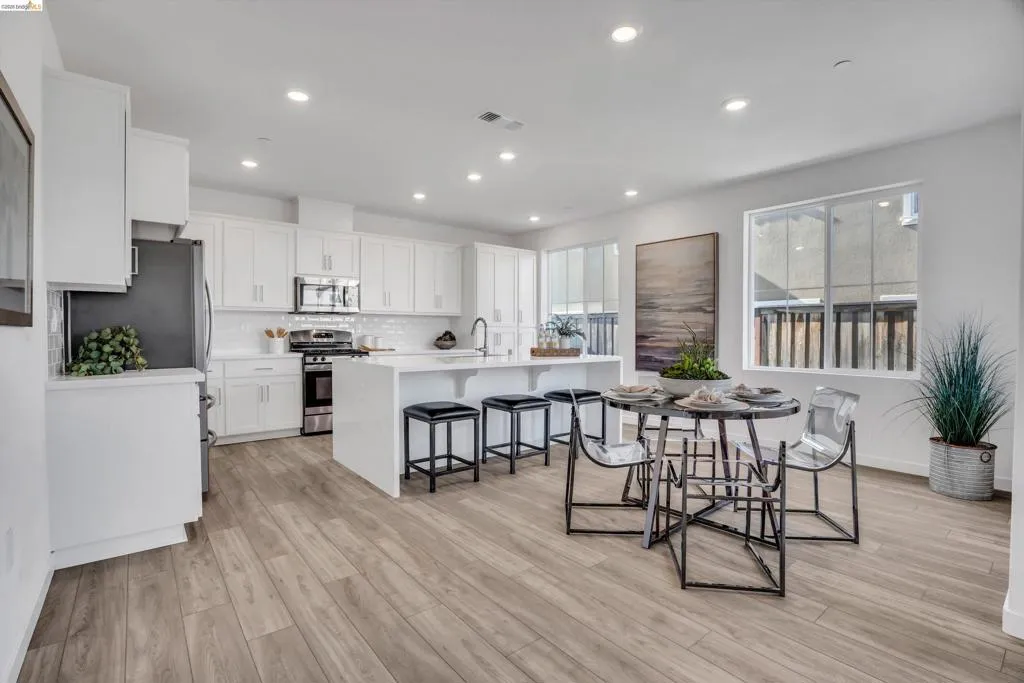 Dining room with light wood-type flooring and recessed lighting