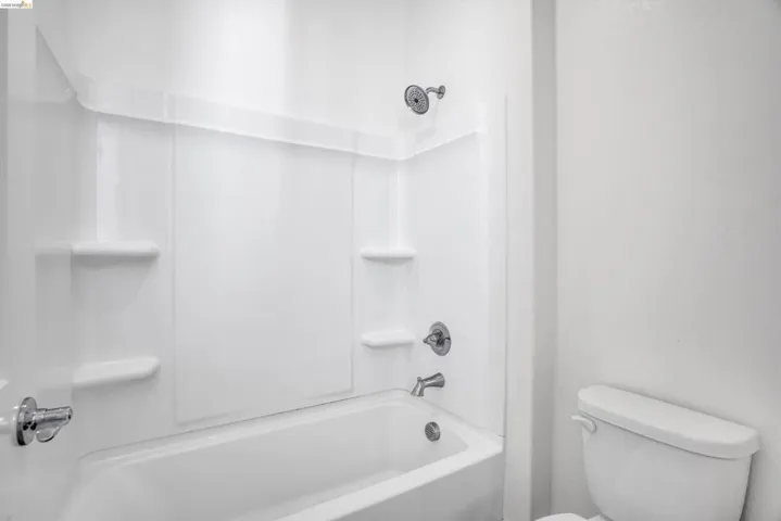 Bathroom with toilet and shower / bath combination