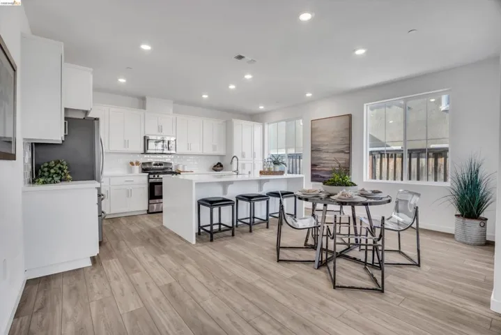 Dining room with light wood-type flooring and recessed lighting