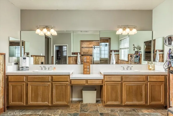 Great vanity with dual basins and make up area.