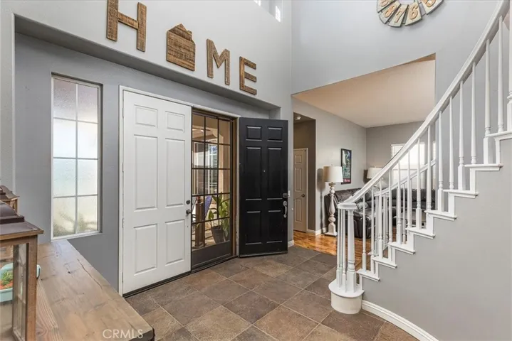 Front entry way with double doors.  High ceilings.  Entry into living room and Next-gen suite.