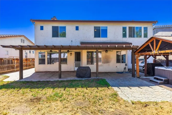 Rear Exterior with stamped concrete patio and Alumawood patio with 3 ceiling fans.