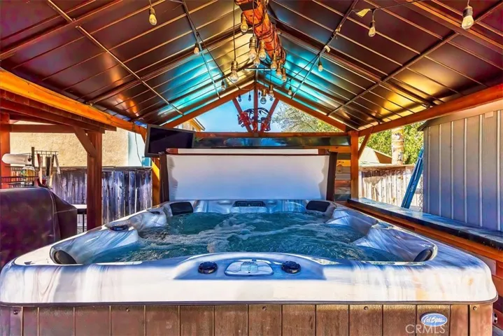 Sparkling clean soothing hot tub.  Approximately 5 years new.  Covered gazebo adds extra privacy or can be easily removed.
