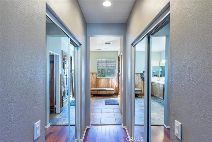 Entrance into remodeled primary bath.  Double closets with mirrored doors.