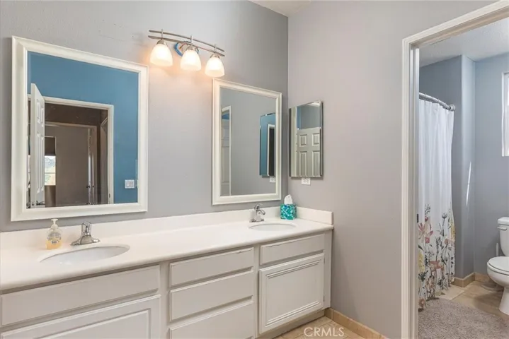 Spacious upstairs bathroom with dual basins.