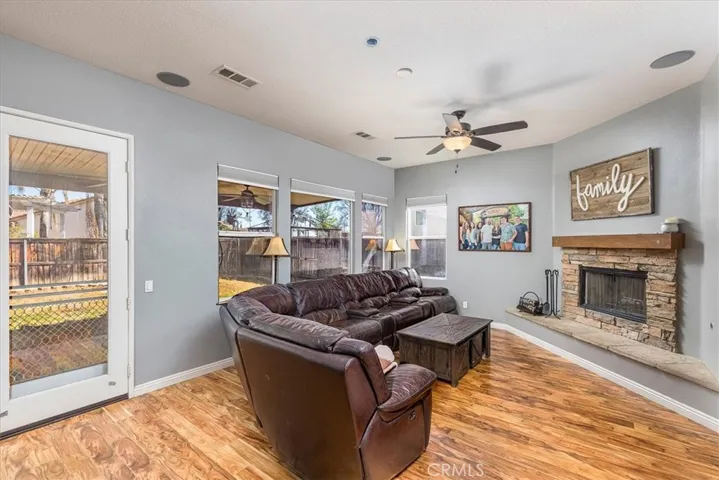Family room with numerous windows looking out to covered patio and back yard.