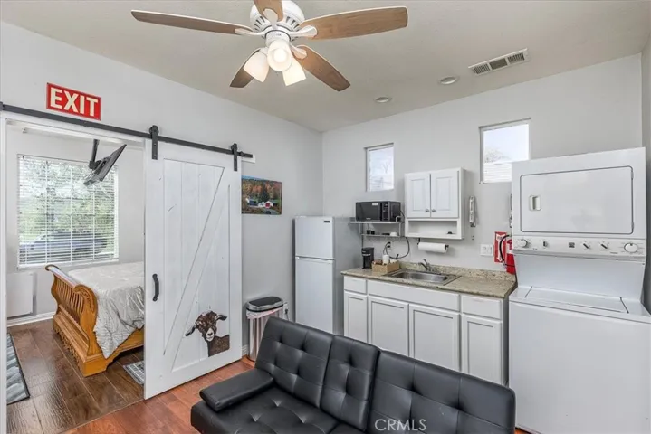 Sliding barn door from living area/kitchenette/laundry looking into bedroom.