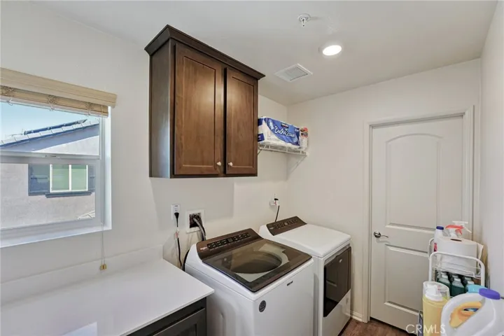 Upstairs Laundry with a large walk in storage closet