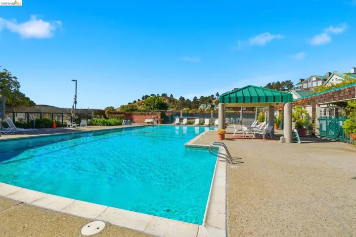 Community pool featuring a patio and a gazebo