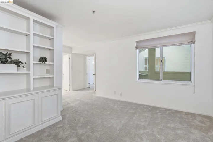 Empty room with light carpet and ornamental molding