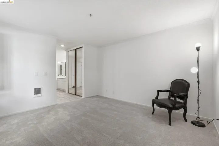 Unfurnished room with crown molding and light carpet