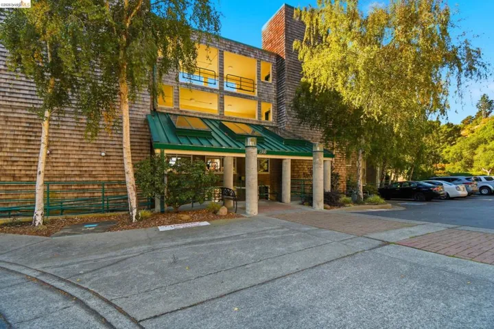 View of building exterior featuring uncovered parking