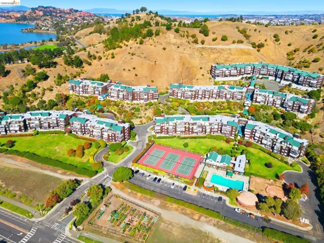 Aerial view of a nearby body of water and apartment complex / building