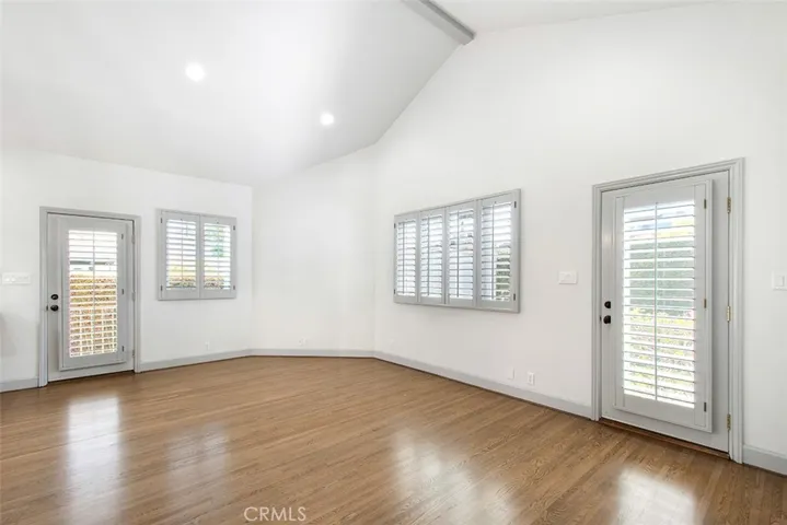 Back Family Room is extremely large w/ high ceilings.  Side door to driveway and back door to the backyard.