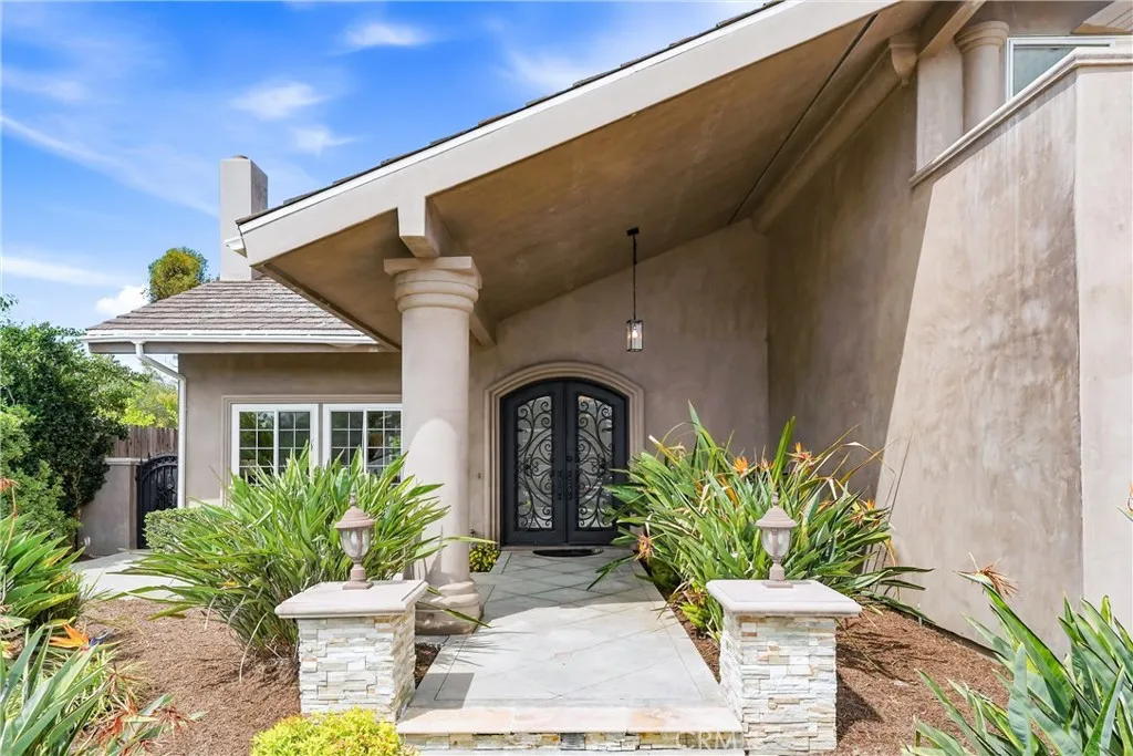 Gorgeous Entrance with Custom Built Iron and Glass Double Door.
