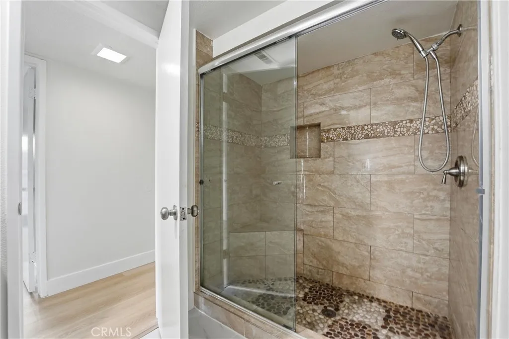 Main Floor Bathroom has standing shower with glass doors.