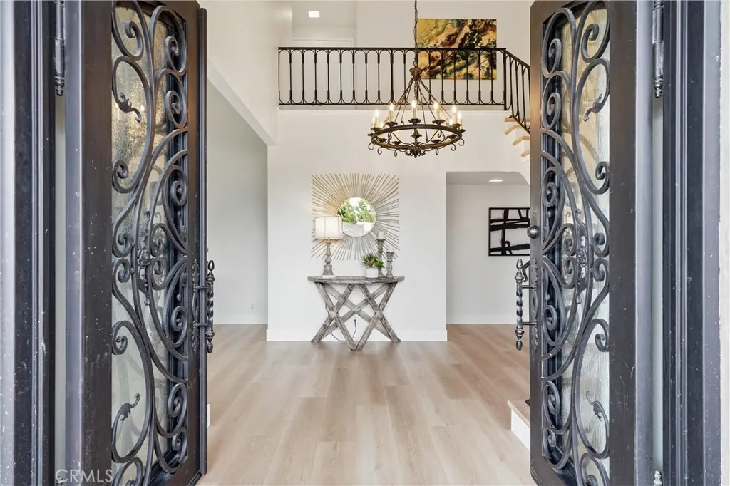 Custom Built Front Door, Elegant Foyer with High Ceiling and beautiful Chandelier.