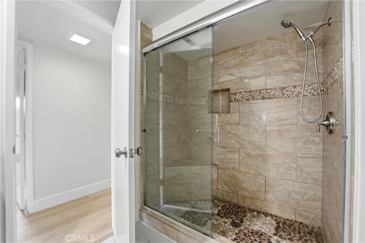 Main Floor Bathroom has standing shower with glass doors.