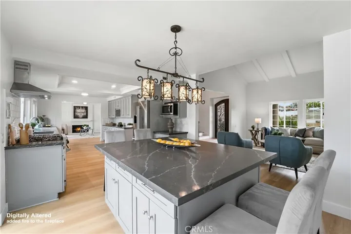 Dining Island, kitchen and part of family room. Fireplace was digitally altered with fire in it.